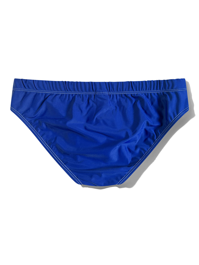 A pair of royal blue swim briefs with white contrast stitching, laid flat against a white background with a soft shadow.