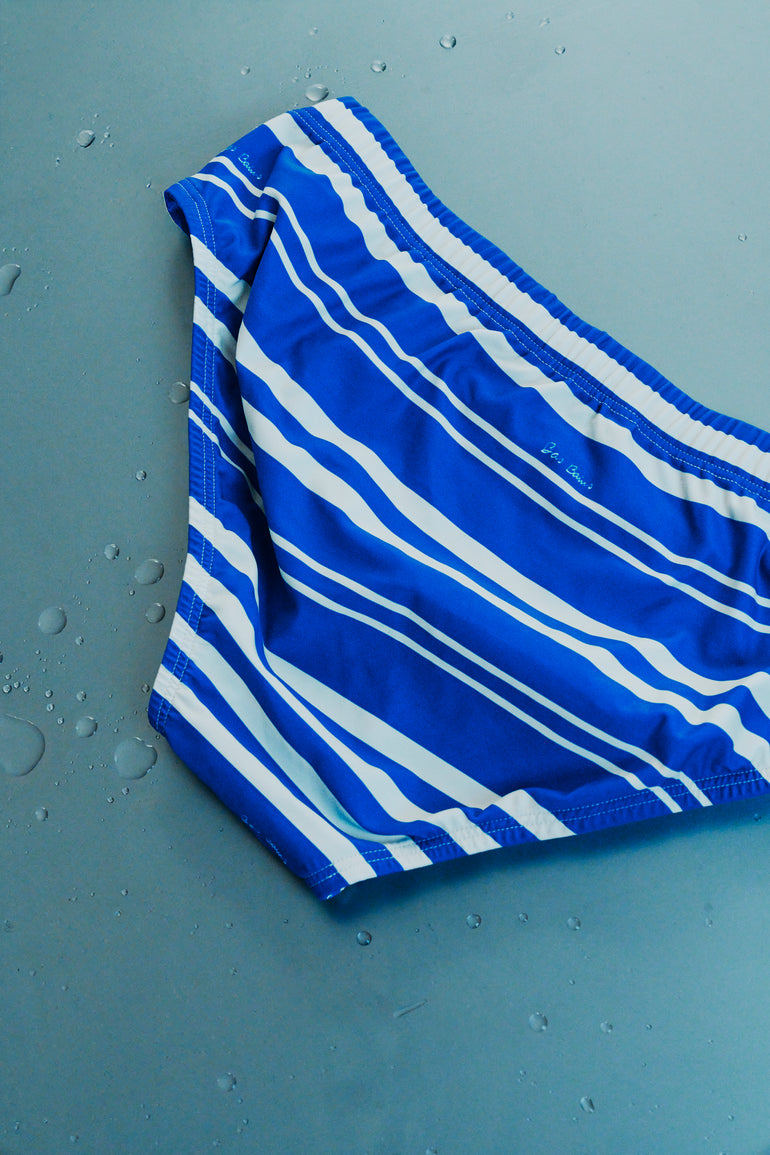 Blue and white striped fabric on a gray surface