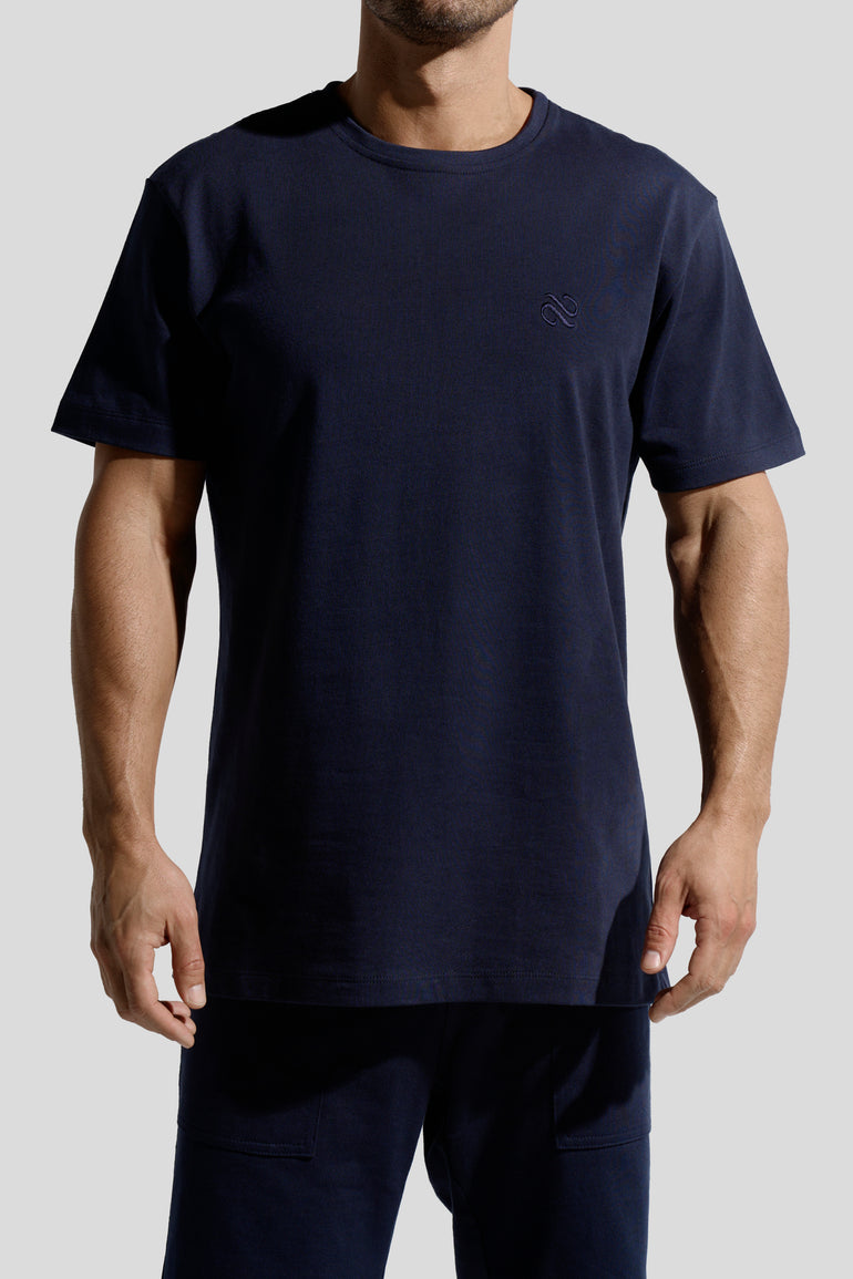 image of organic cotton T-shirt in Marino Blue front view on male model by Bas Bains