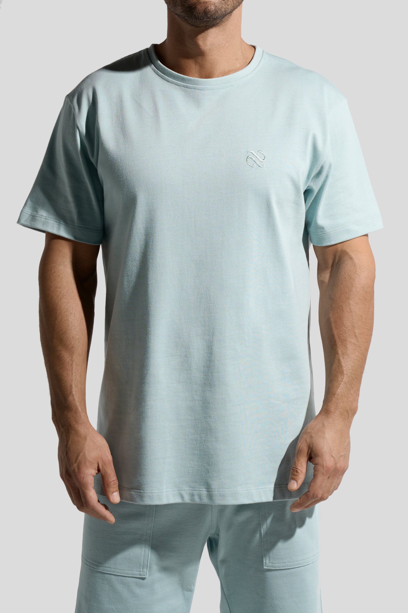 image of organic cotton T-shirt in Menta green front view on male model by Bas Bains