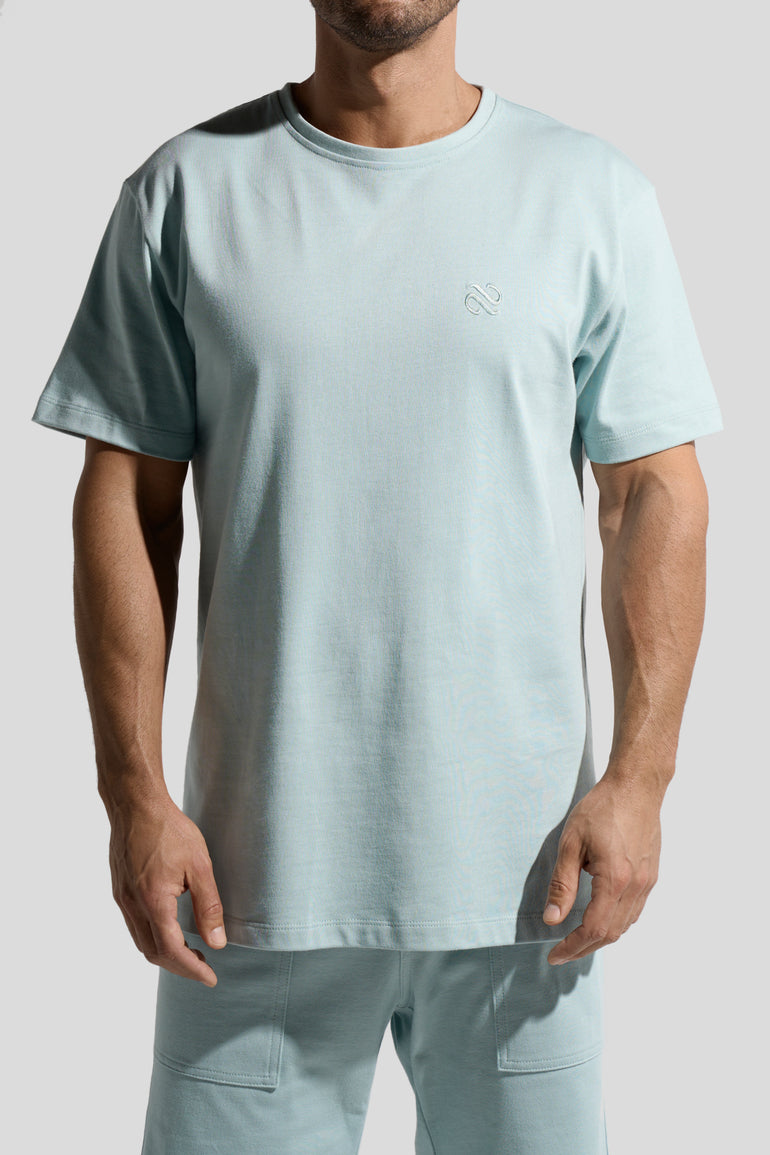 image of organic cotton T-shirt in Menta green front view on male model by Bas Bains