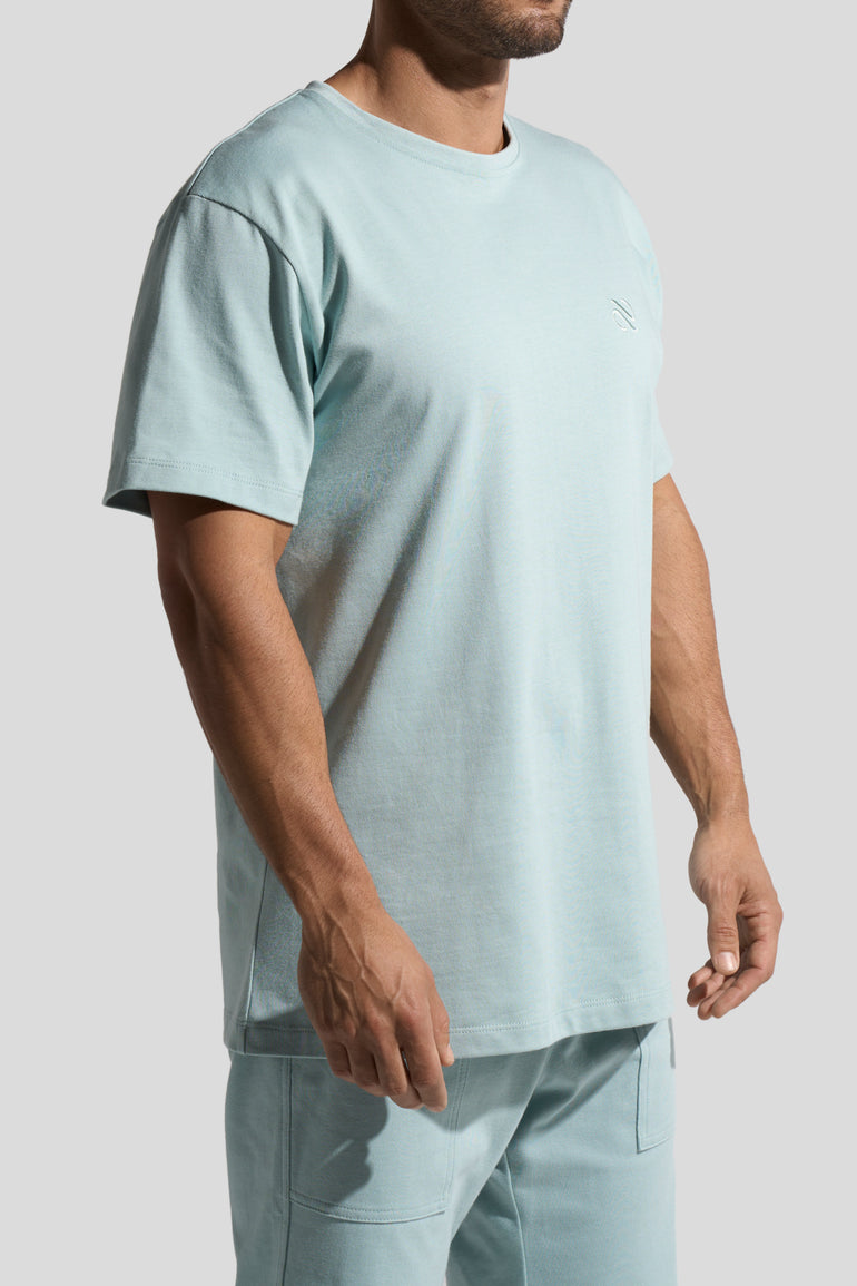 image of organic cotton T-shirt in Menta green side view on male model by Bas Bains