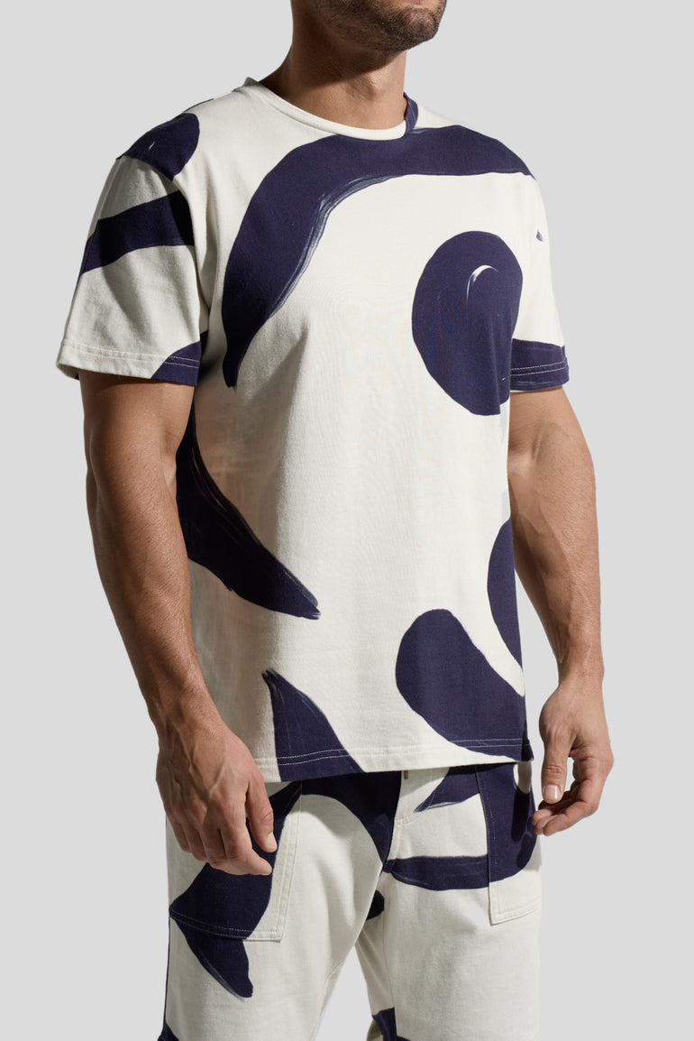image of organic cotton T-shirt in Rivage print side view on male model by Bas Bains